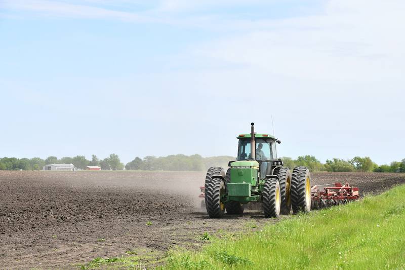 A farmer tills a field in rural Kankakee near Grinnell Road as planting began in 2024.