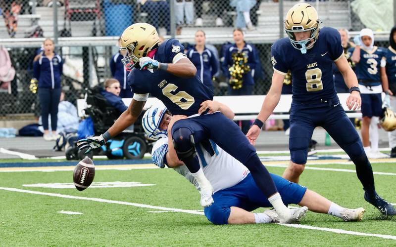 Princeton's Grady Cox puts the hit on Bloomington Central Catholic's Valshun Powe and causes a fumble in Saturday's 3A playoff opener in Bloomington.