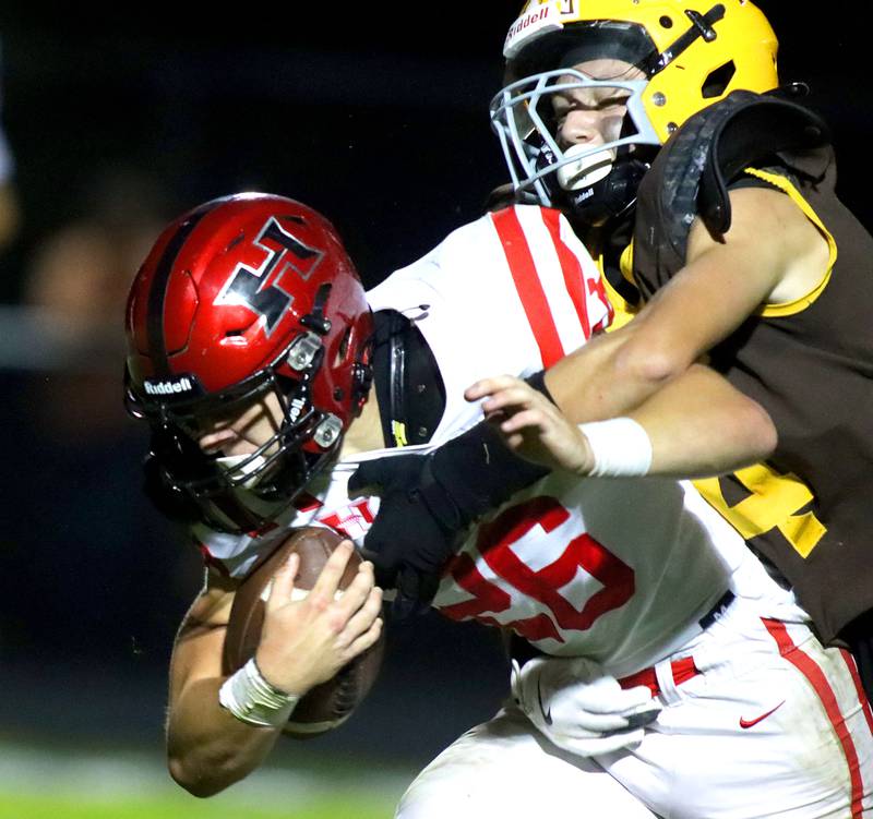 Huntley’s Chase Hojnacki is brought down by Jacobs’ Cooper Dolson at Jacobs High School in Algonquin on Friday, Sept. 26, 2025.