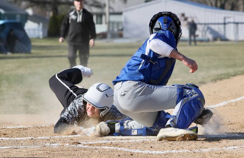 Rock Falls' Owen Mandrell slides in under the tag of Princeton catcher Ace Christiansen to score a first-inning run Thursday at Prather Field. The host Tigers won 5-4.