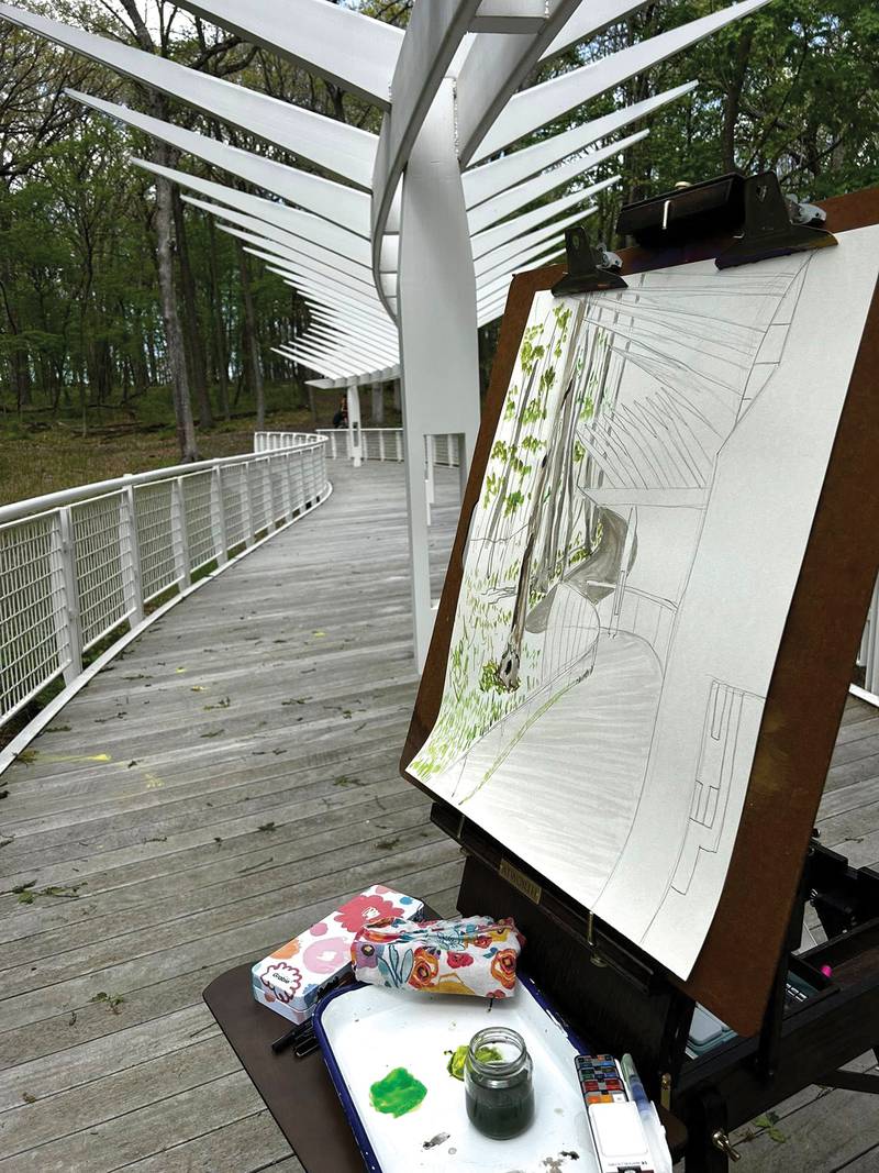 An in-progress plein air painting by Amanda Weygand Zehr stands on the bridge at Nell's Woodland in Ottawa.