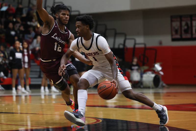 Bolingbrook’s Mekhi Cooper works around Lockport’s Jalen Falcon on Friday, February 10th.