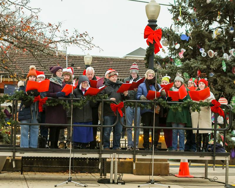 The Downers Grove Coral Society warm up on Friday Nov. 29, 2024, before the start of the Downers Grove Christmas tree lighting ceremony in downtown Downers Grove.