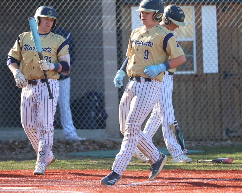Marquette's Jaxsen Higgins scores a run against Newark on Monday, March 23, 2026 at Newark High School.