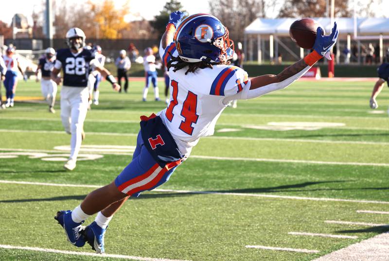 East St. Louis' Rico Bond makes a diving attempt to make a catch on the sideline Saturday, Nov. 25, 2023, during their IHSA Class 6A state championship game against Cary-Grove in Hancock Stadium at Illinois State University in Normal.