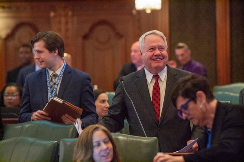 State Rep. Jay Hoffman, D-Swansea, smiles on the House floor after Republicans chose not to debate his proposed election law changes, instead voting present then leaving the chamber for a news conference.