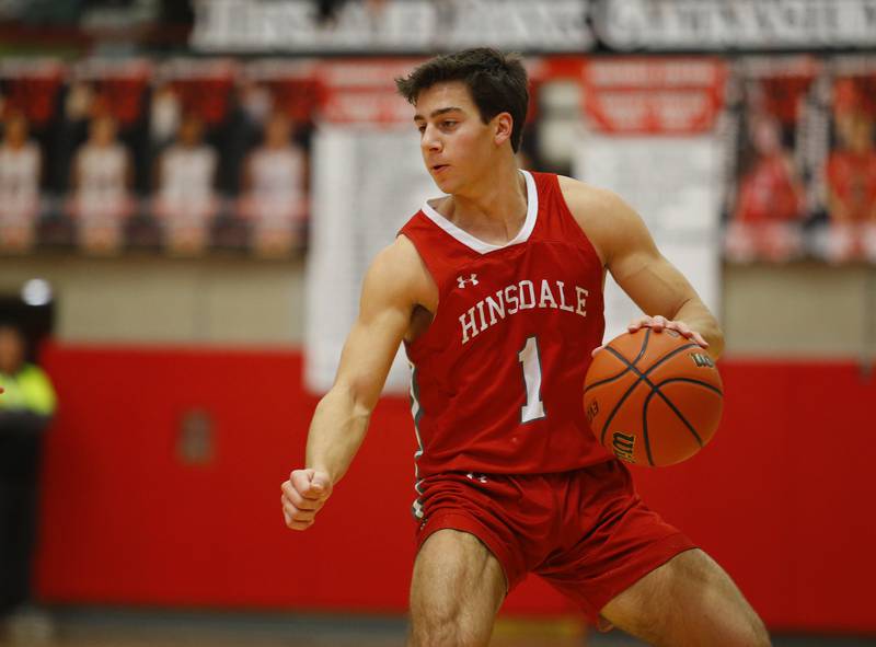 Hinsdale Central's Evan Phillips (1) brings the ball up during the Hinsdale Central Holiday Classic championship game between Oswego East and Hinsdale Central high schools on Thursday, Dec. 29, 2022 in Hinsdale, IL.