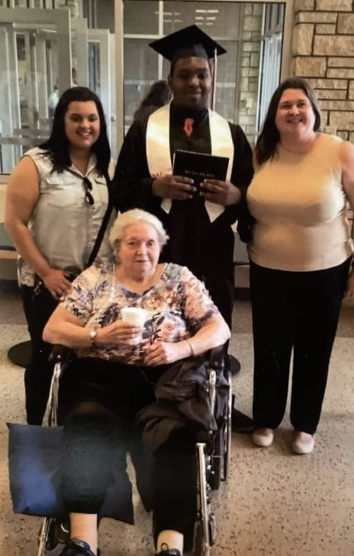 Former Wilmington resident Carol Juricic is pictured with her daughter Sheila (left) and Jeanette (right) at her son Tony's high school graduation. Carol and her husband Paul cared for more than 250 foster children over 25 years and adopted four children.