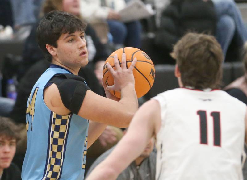 Marquette's Matthew Graham looks to pass the ball around Woodland's Nate Berry during the Tri-County Conference Tournament championship on Friday, Jan. 30, 2026 at Putnam County High School.