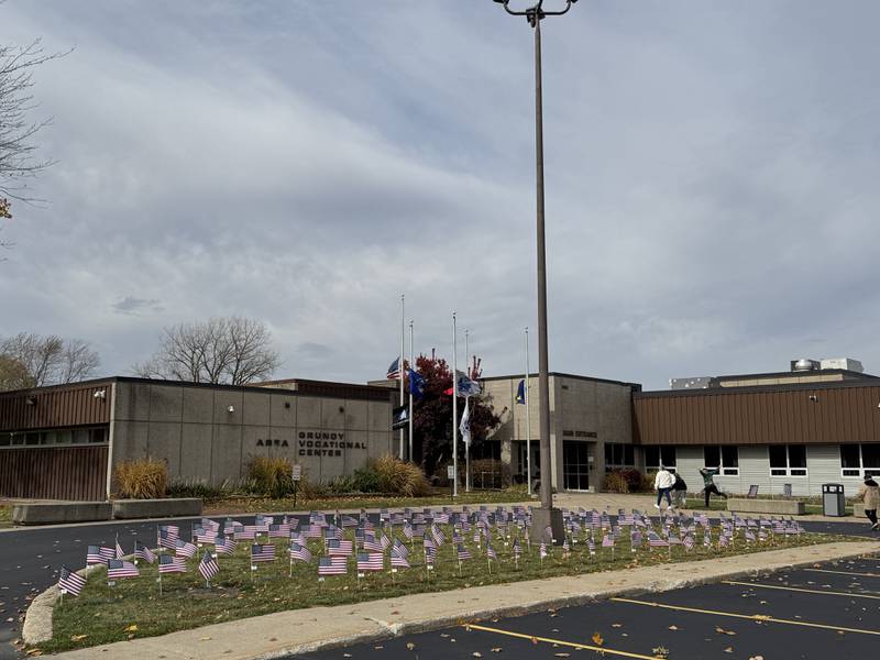 Many American flags honoring veterans cover the front lawn at the Grundy Area Vocational Center on Tuesday, Nov. 11, 2025.