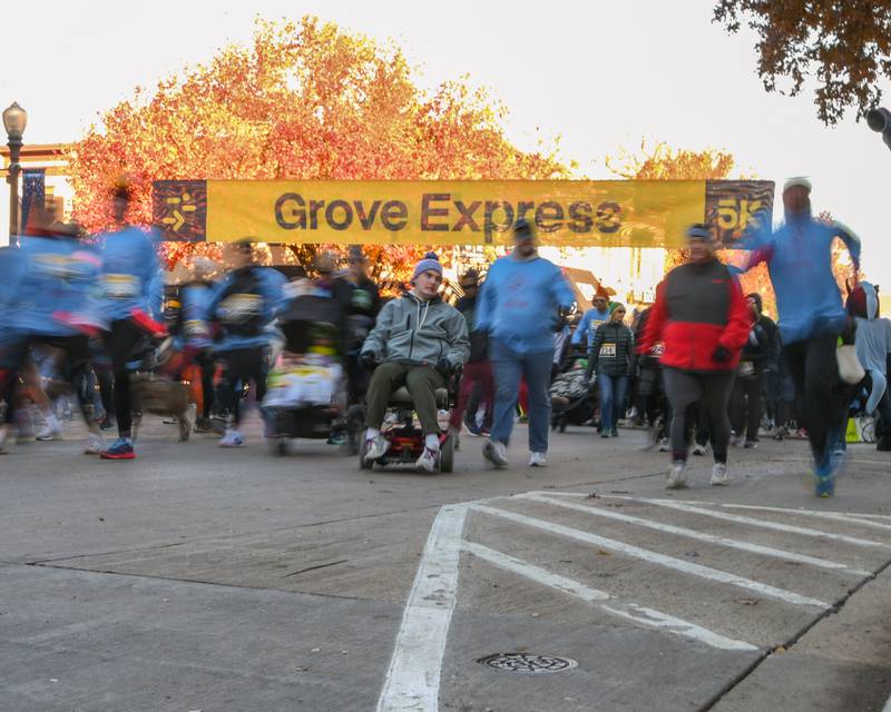 Participants take off from the start line during the Grove Express 5k on Thursday Nov. 23, 2023, held in downtown Downers Grove.