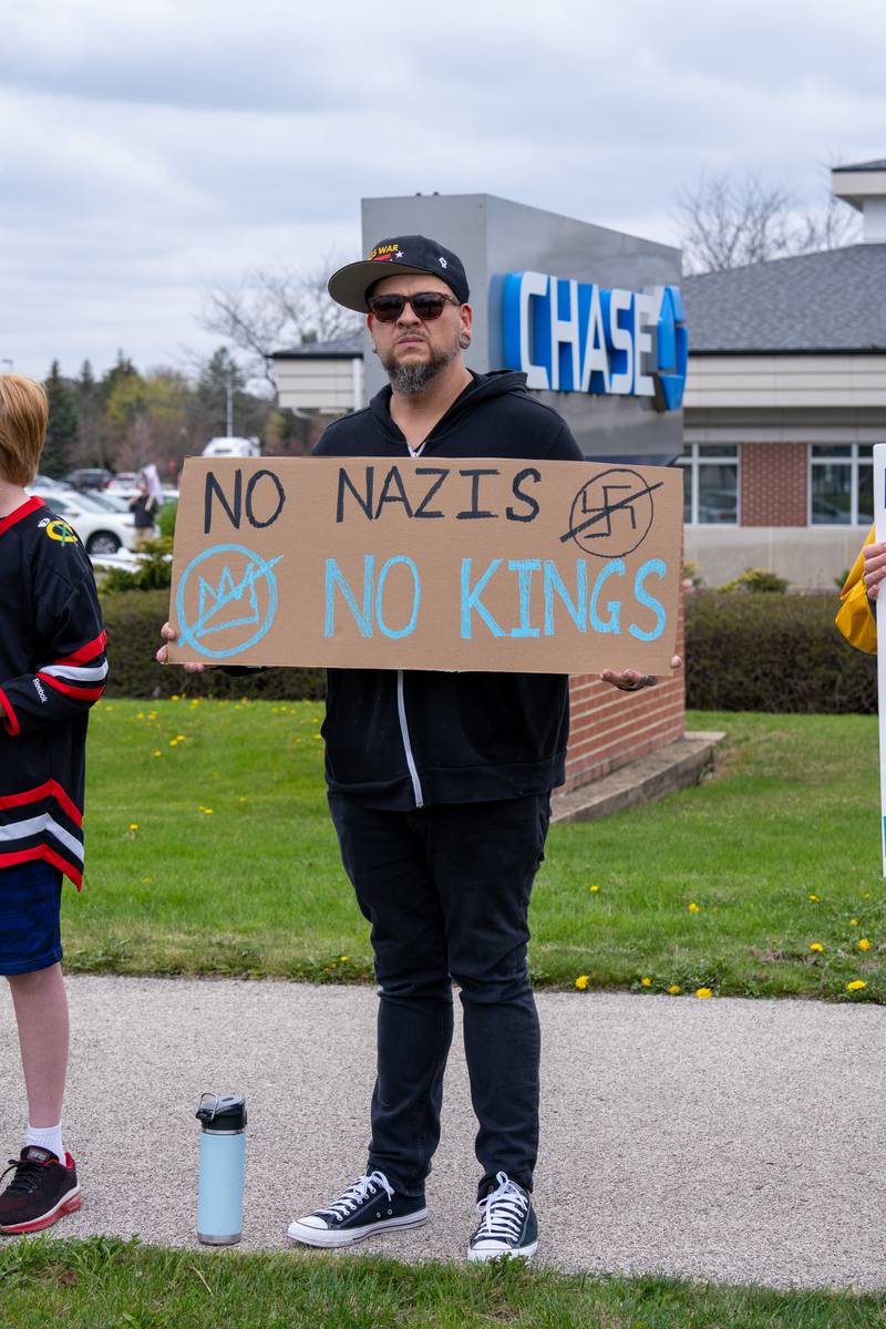 Protesters hold up protest signs along Randall Road in South Elgin, IL to protest their issues with President Donald J. Trump and his administration and Elon Musk involvement in US government affairs on Saturday April 19, 2025.  Hundreds of protesters participated in the latest Hands Off protest occurring in the Chicagoland area and the rest of the country.