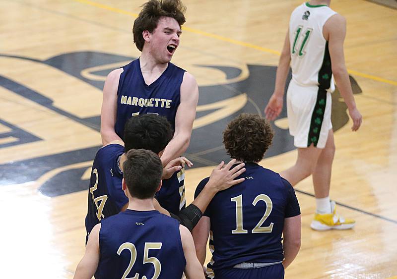 Marquette's Tommy Durdan (top) reacts with teammates Taylor Waldron, Denver Trainor and Krew Bond after defeating Seneca in the Tri-County Conference championship on Friday, Jan. 27, 2023 at Putnam County High School.