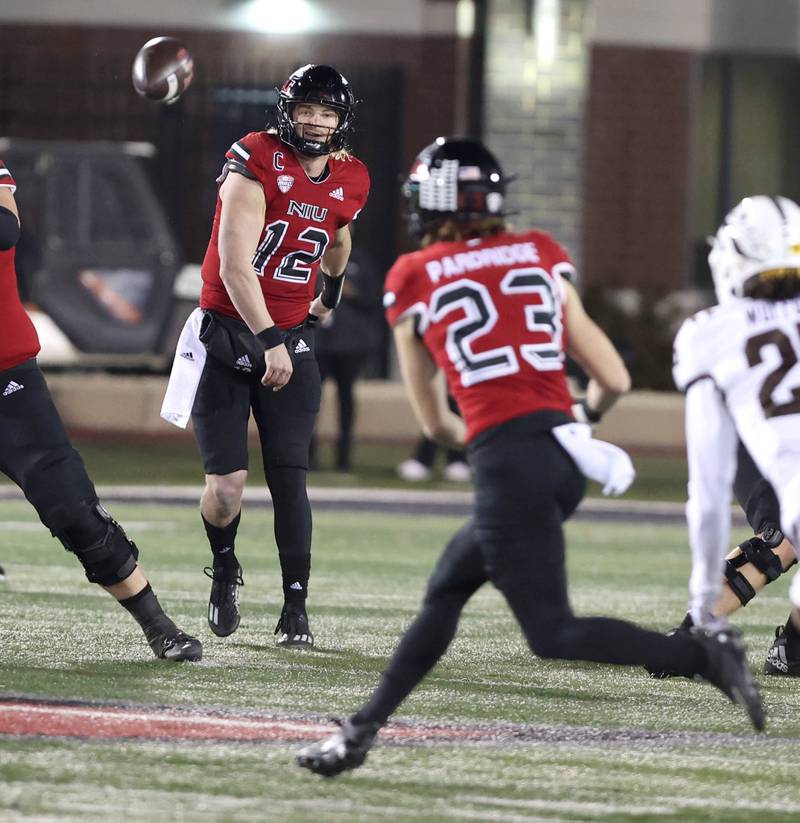 Northern Illinois' Rocky Lombardi completes a pass to Northern Illinois' Dane Pardridge in front of Western Michigan's Aaron Wofford during their game Tuesday, Nov. 14, 2023, in Huskie Stadium at NIU in DeKalb.