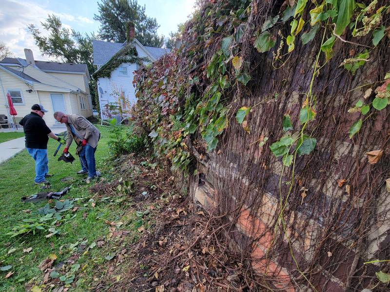 Labor of Love volunteers clean up some of the debris removed from a midtown Ottawa garage during the effort on Saturday.