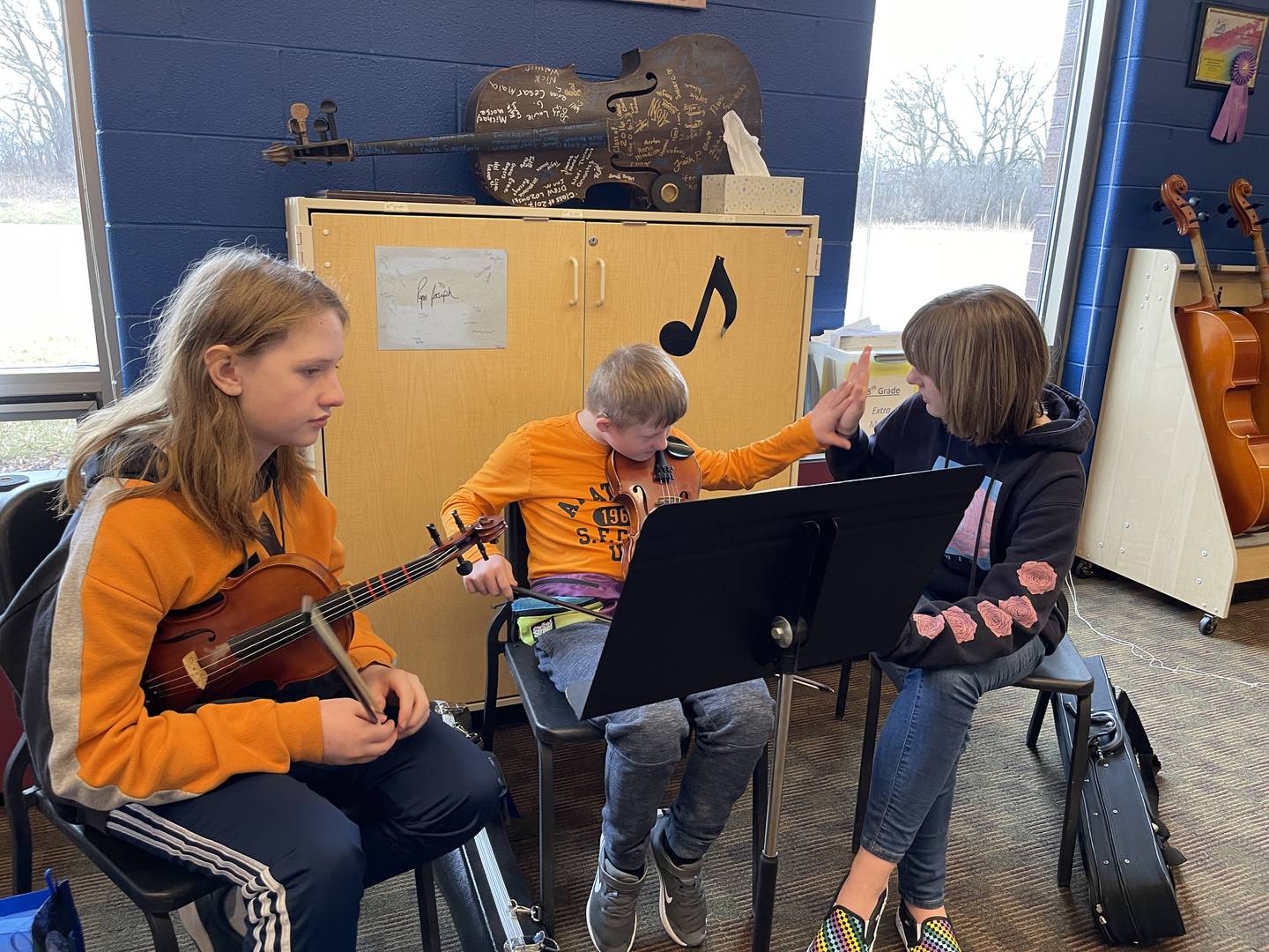 From left to right, Lucas Balgeman, Luca Slabinski and Mackenzie Green practice music on Friday, Jan. 13, 2023, at Creekside Middle School, as part of the United Sound program. United Sound is geared toward removing social barriers through music. At Creekside, it provides students in special education the opportunity to learn how to play while receiving social interaction.
