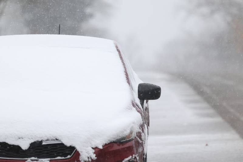 Snow covers a car in a residential area of Joliet on Thursday, Nov. 21, 2024.