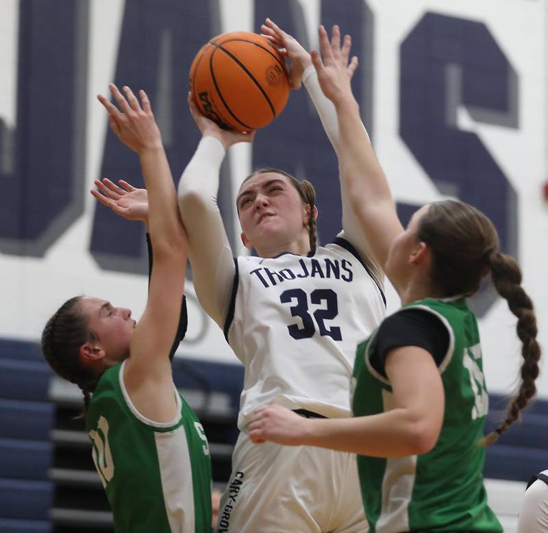 Cary-Grove's Olivia Leuze shoots the ball between Crystal Lake South's Mallory Glover (left) and Tessa Melhuish (right) during a Fox Valley Conference girls basketball game on Tuesday, Dec. 2, 2025, at Cary-Grove High School in Cary.