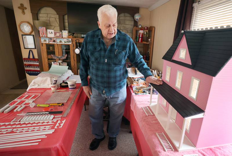 Sycamore resident Lee Newtson points out some features Thursday, March 24, 2022, on the doll house he has built that will be raffled off as a fundraiser to benefit Ukraine.