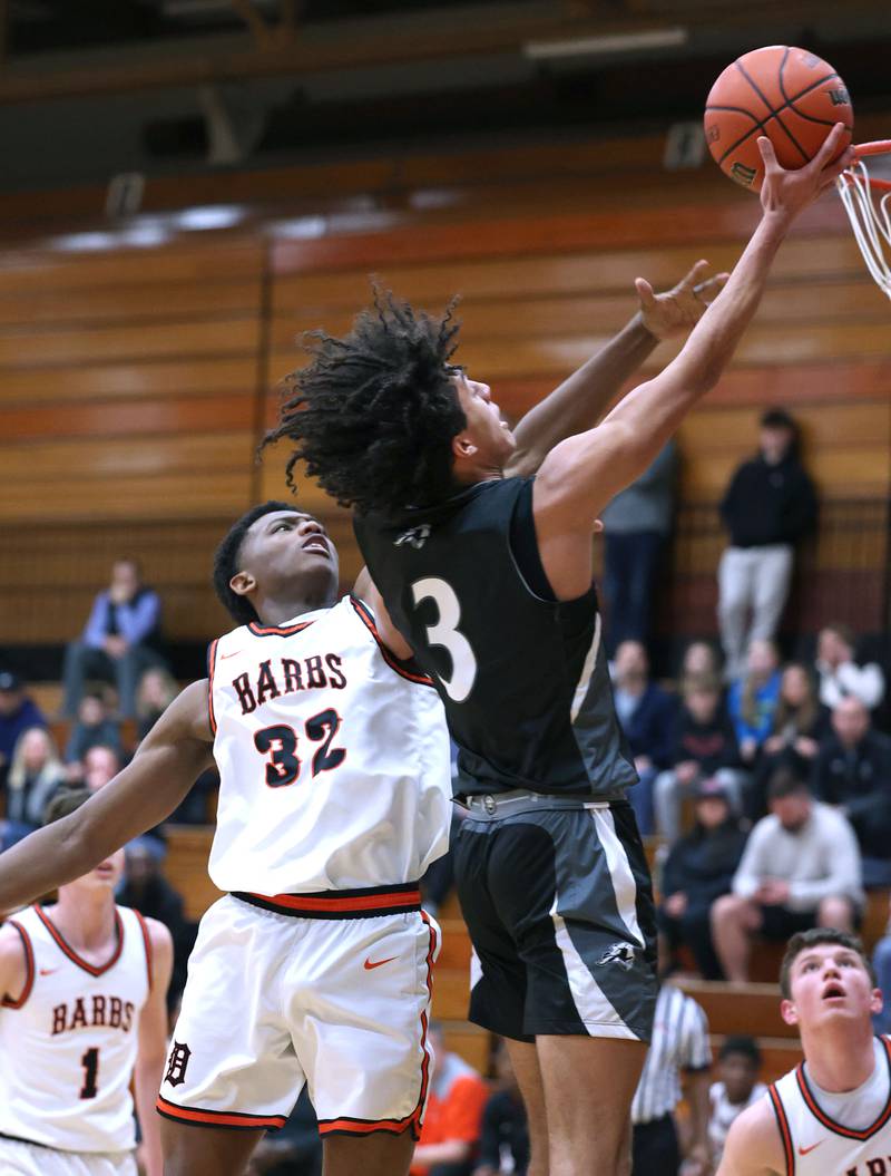 Kaneland's Evan Frieders goes to the basket in front of DeKalb’s Justin O’Neal during their game Monday, Feb. 12, 2024, at Huntley Middle School in DeKalb.