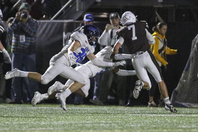 Lincoln-Way East's Colton Zvonar (36) chases down Mount Carmel's Emmett Dowling (7) during Class 8A quarterfinal football game between Lincoln-Way East at Mount Carmel. Saturday, Nov 15, 2025 in Chicago.