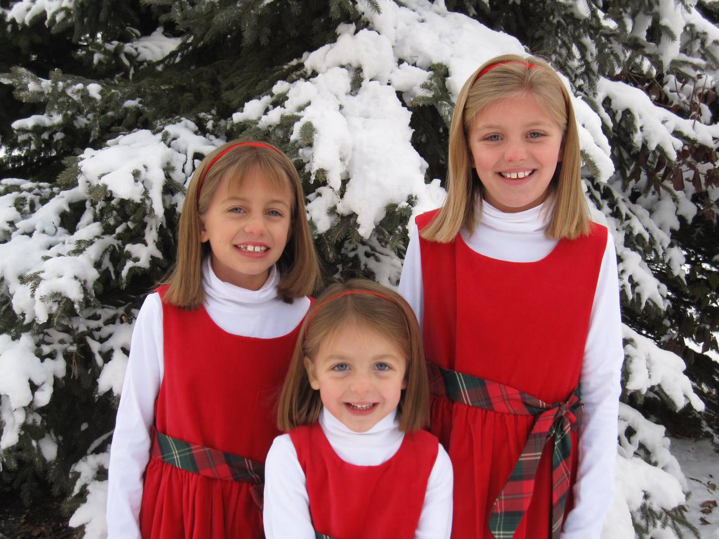Emma, Jane, and Catherine Carter (from left to right) in front of the family's spruce tree in 2010.