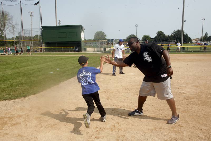 Wes Chamberlain offers a high five during a base running drill.