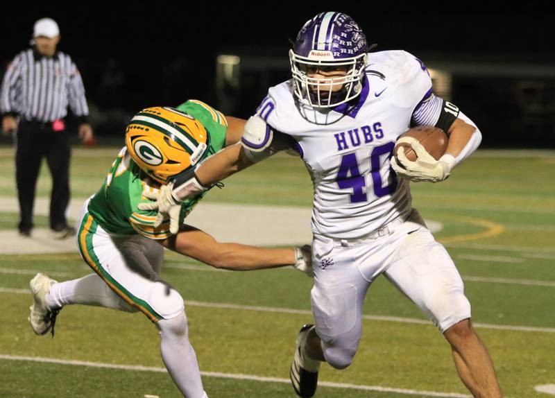 Rochelle's Roman Villalobos (40) fights off a Geneseo defender during Friday's game at Geneseo.