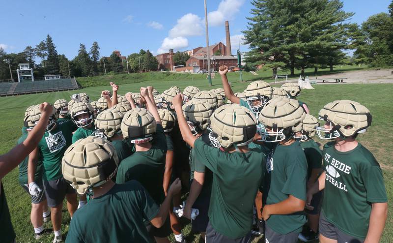 Members of the St. Bede football team huddle during the first day of football practice on Monday, Aug. 11, 2025 at St. Bede Academy.