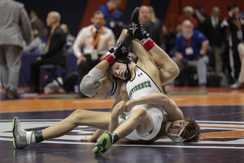 Providence Catholic’s Max Mandac and IC Catholic’s Sammy Murante compete in the 2A 126 pound title Saturday, Feb. 21, 2026, at the IHSA wrestling finals in Champaign.