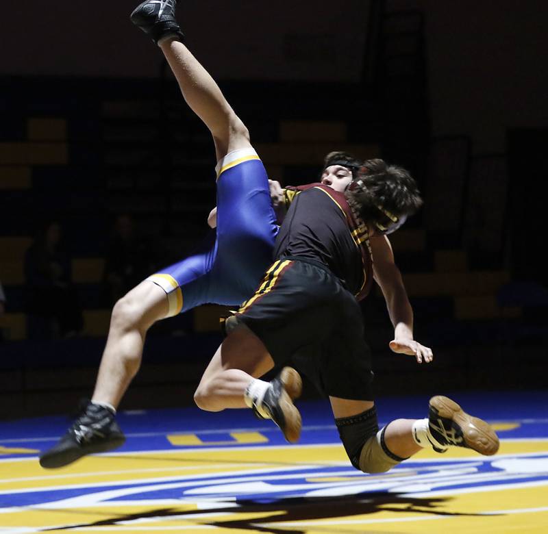 Richmond-Burton’s Adam Glauser tries to take down Johnsburg’s Chase Davis in the 120-pound match of a Kishwaukee River Conference wrestling meet on Thursday, Jan. 30, 2025, at Johnsburg High School.