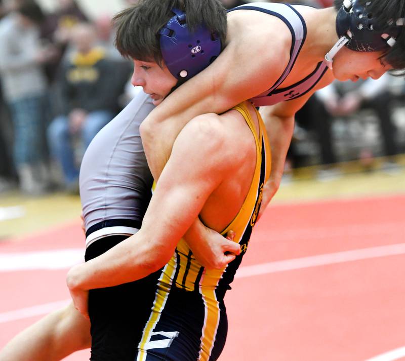 Polo's Josiah Perez lifts Lisle's Ryan Hsu during their 106-pound match at the 1A Oregon Wrestling Sectional on Friday night.