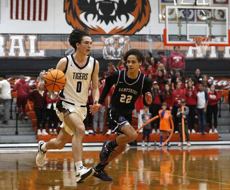 Crystal Lake Central's Jackson Hopkins pushed the ball up the court against Hampshire's Jaiden Baldwin during a Fox Valley Conference basketball game on Friday, Feb. 7, 2025, at Crystal Lake Central High School.