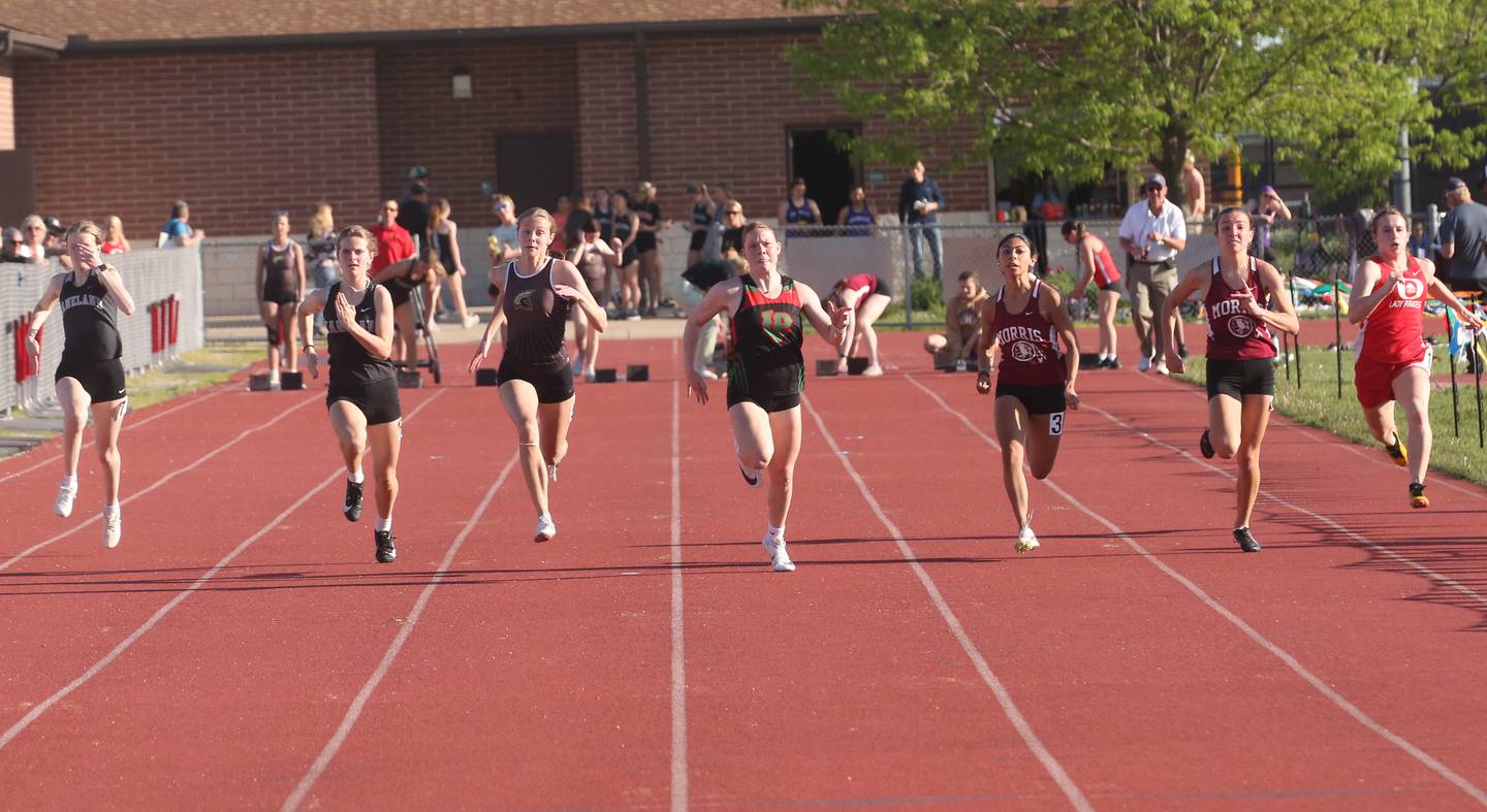 (From left) Kaneland's Chloe Parker and teammate Ellie Olp, Sycamore's Alyssa Stacy, L-P's Elli Sines, Morris's Gisselle Reyes and teammate Ava Conley, and Ottawa's Ashlynn Gainere all compete in the 100 meter run during the Interstate 8 conference track meet on Friday, May 3, 2024 at the L-P Athletic Complex in La Salle.