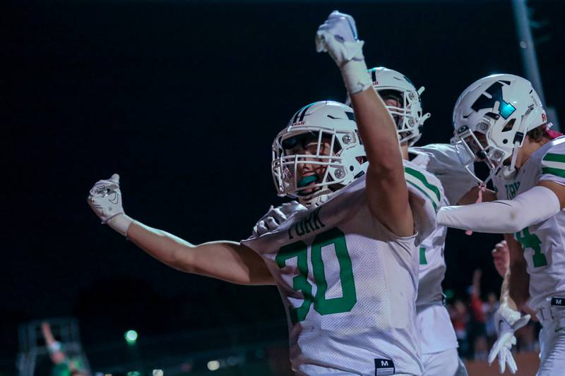 York's Jake Mellon (30) celebrates a touchdown run through the Downers North defense during football game between York at Downers Grove North.  Sept 29, 2023.