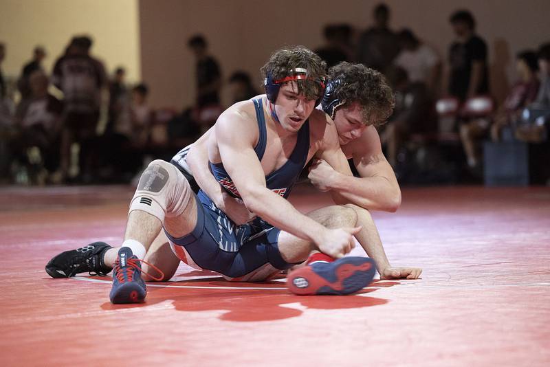 Dixon’s Seth Shaffer (back) and Morrison’s Noah Stout in the 190 pound weight class in the Class 1A wrestling sectionals at Oregon.