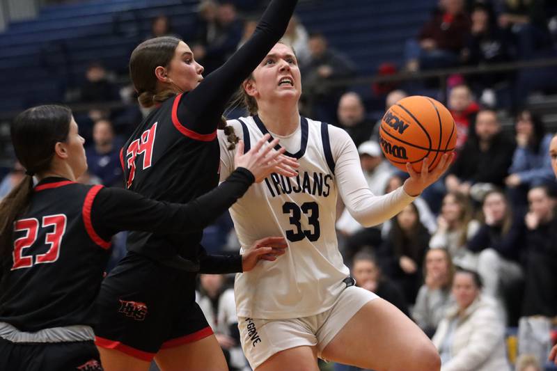 Huntley’s Ava McFadden, center, guards Cary-Grove’s Elizabeth Mjaanes, right, in varsity girls basketball on Friday, Jan. 24, 2025, at Cary-Grove High School in Cary.