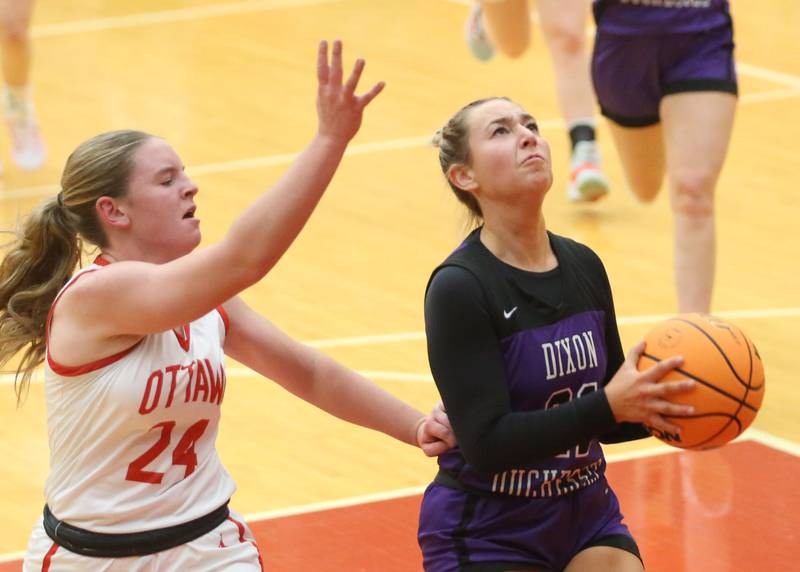Dixon's Reese Dambman runs in the lane past Otawa's Kennedy Kane on Wednesday, Dec. 3, 2025 in Kingman Gymnasium at Ottawa High School.