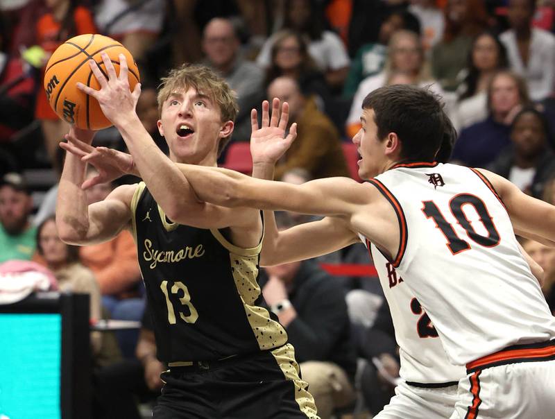 Sycamore's Xander Lewis is fouled by DeKalb's Jack Rosenow Friday, Jan. 30, 2026, during the FNBO Challenge at the Convocation Center at Northern Illinois University in DeKalb.