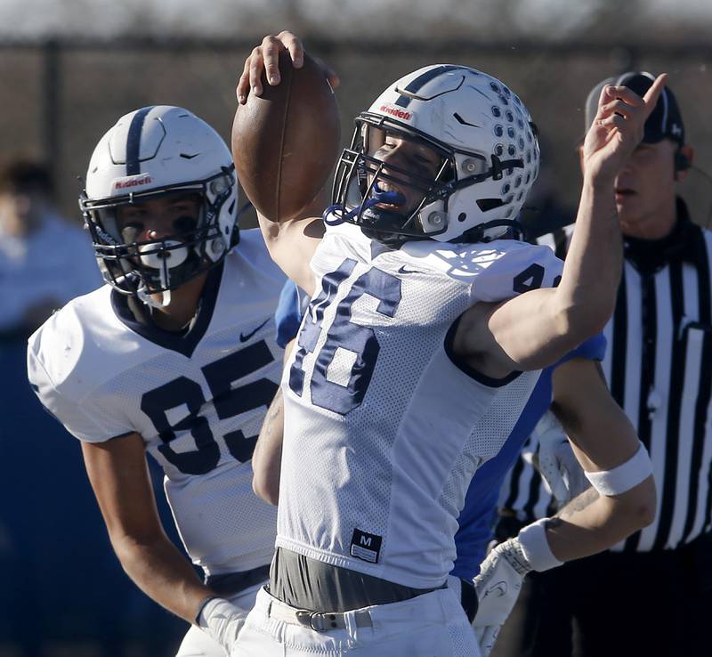 Cary-Grove's Logan Abrams celebrates a touchdown with his teammate, Luca Vivadelli, during a IHSA Class 6A semifinal playoff football game against Lake Zurich on Saturday, Nov. 18, 2023, at Lake Zurich High School.