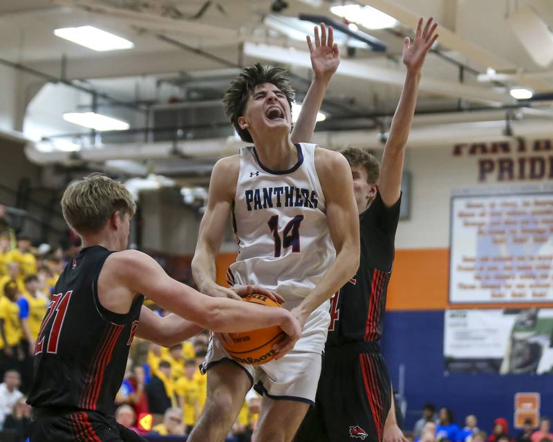 Oswego's Niko Jurkovic (14) gets tied up by Yorkville's Frankie Pavlik (21) during their basketball game between Yorkville at Oswego, Feb 7, 2026 in Oswego.