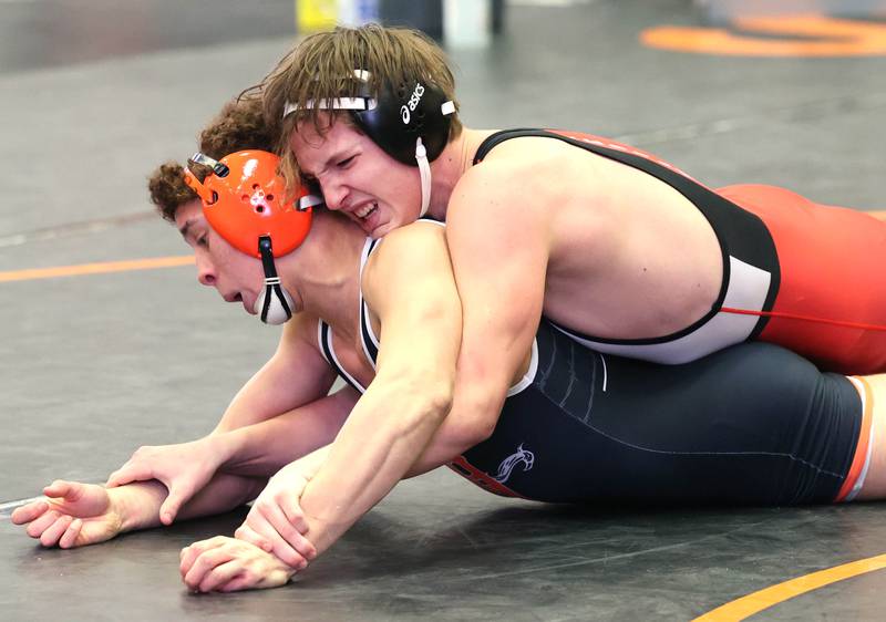 Naperville Central’s Henry Rydwelski works to turn DeKalb’s Adrian Franco in their 170 pound semifinal match Friday, Jan. 20, 2023, during the DuPage Valley Conference wrestling tournament at DeKalb High School.