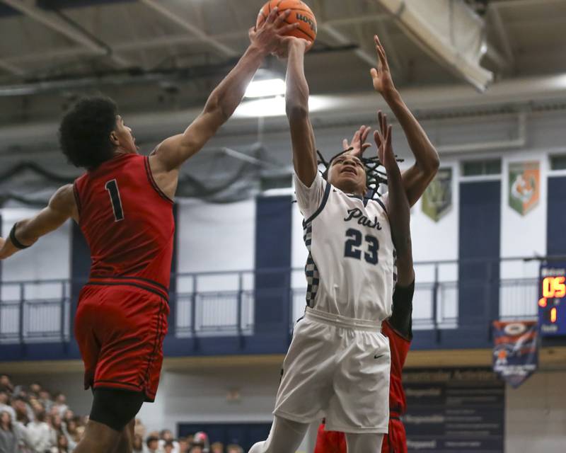 Bolingbrook's Brady Pettigrew (1) blocks the shot of Oswego East's Mason Lockett (23) during their basketball game between Bolingbrook at Oswego East Friday, Jan 30, 2026 in Oswego.