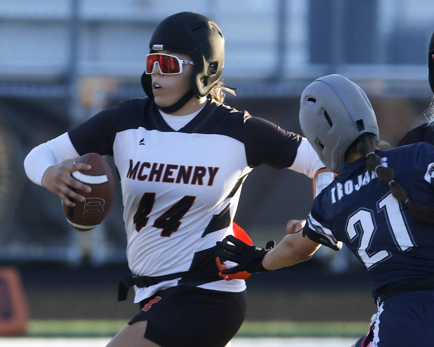 McHenry's Brooklyn Anderson runs with the ball as Cary-Grove's Claire Williams tries to grab her flag during the IHSA McHenry Regional girls flag football championship game on Wednesday, Oct. 8, 2025, at McCracken Field in McHenry.