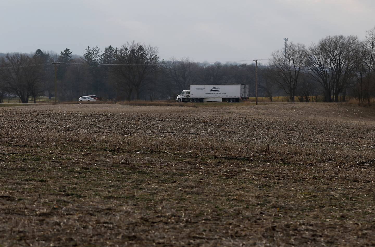 Traffic drives past a farm field on Wilmot Road on Monday, Nov. 28, 2022, in Spring Grove, which was purchased by Super Aggregates to develop into a gravel pit. The Bryants and their neighbors oppose the farm land being converted into a gravel pit.