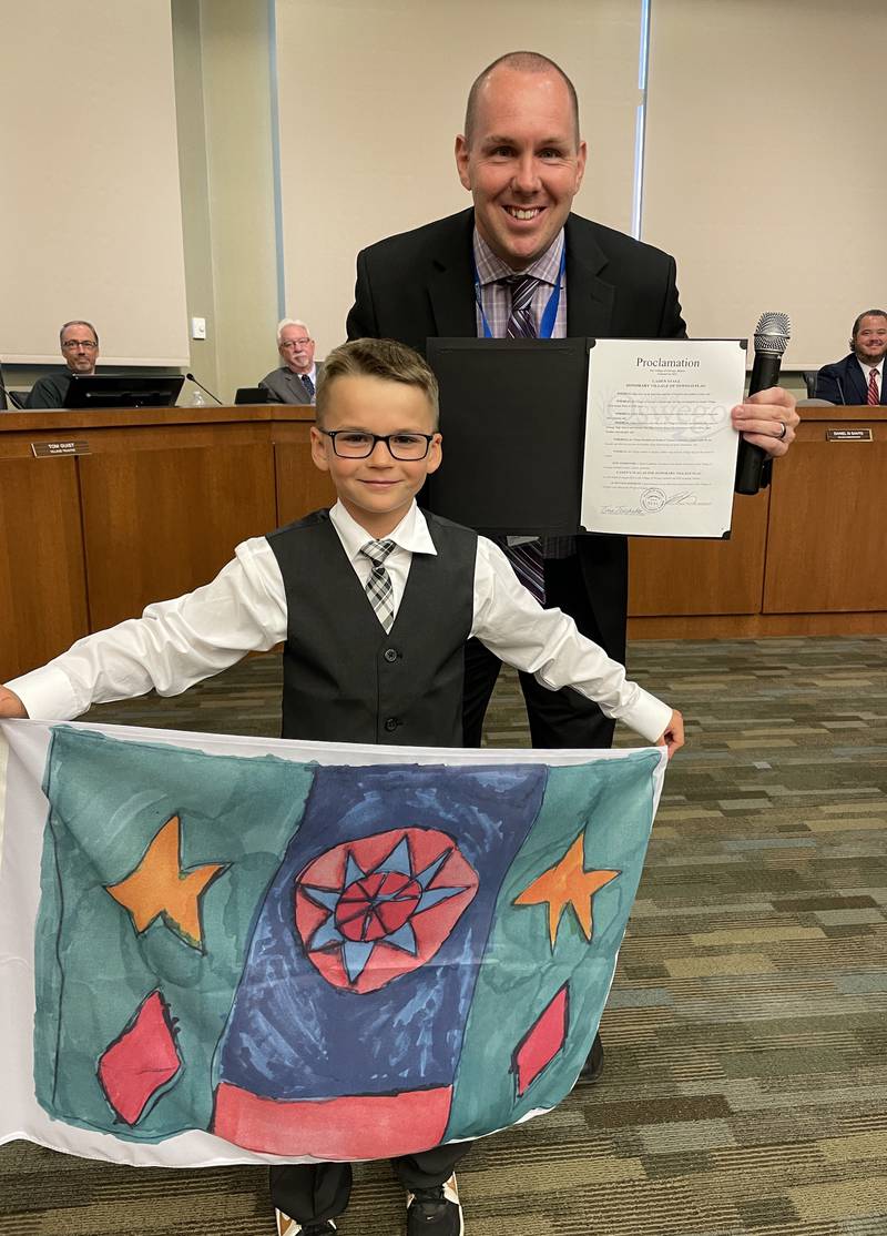 Nine-year-old Oswego youngster Caden Stagl designed a new flag for the village. For the rest of August, his flag will be flying alongside the village’s current flag at the Oswego Village Hall. At the Aug. 8 Oswego Village Board meeting, Oswego Village President Ryan Kauffman read a proclamation designating Caden's flag as the honorary village flag for the month of August.