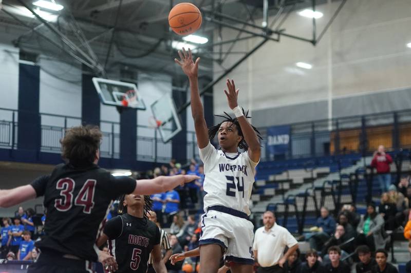 Oswego East's Mason Lockett IV (24) shoots the ball against Plainfield North's Quintin Wiencek (34) during a basketball game at Oswego East High School on Friday, Dec. 6, 2024.
