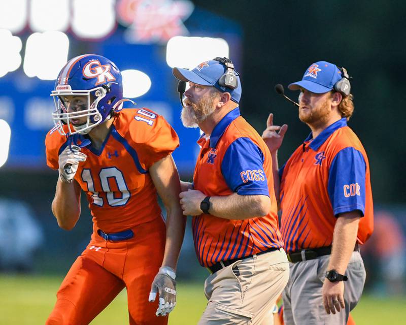Genoa-Kingston’s head football coach Cam Davekos talks to Gavin Havener (10) before sending him in for a play Friday Sep. 16th while taking on Byron at Genoa-Kingston