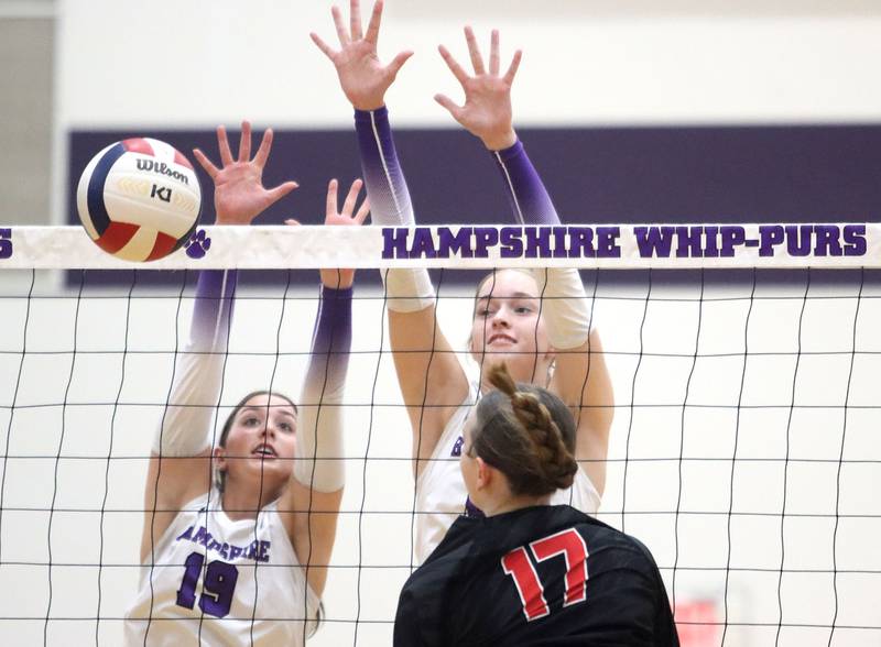 Hampshire’s Katelynn Petterson, left, and Anna Schiltz block in varsity girls volleyball at Hampshire High School in Hampshire on Tuesday, Sept. 23, 2025.