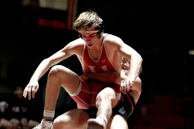 Crystal Lake Central’s Alessio Pezzella throws Huntley’s Shane McGuine in a 150-pound bout in varsity wrestling at Crystal Lake Friday. Pezzella won the match.